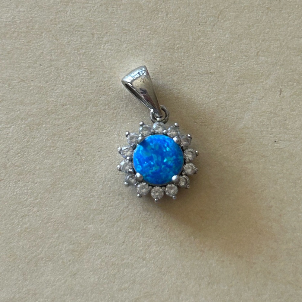 Sterling silver sun with blue stone pendant